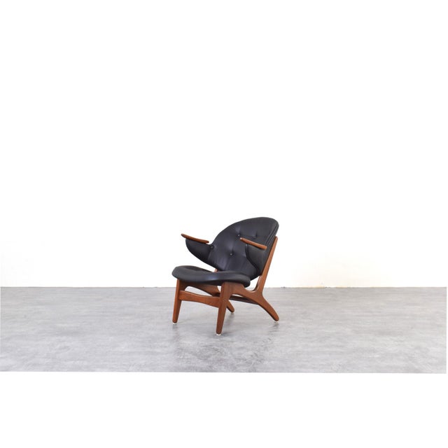 This armchair model 33 was designed by Carl Edward Matthes in the 1950s. The wooden frame of the armchair is made of solid...