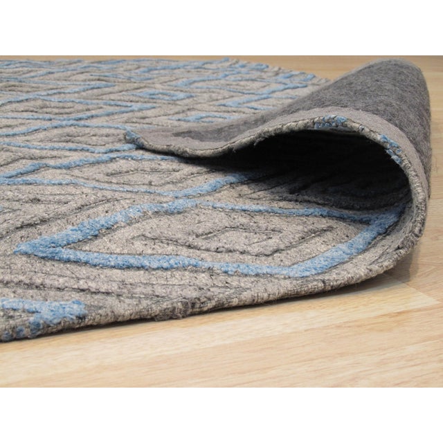 Timeless Trellis Gray Hand Knotted Wool & Viscose Rug, Country of Origin: India. This exceptional hand-knotted piece...
