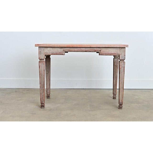An exceptional Swedish Gustavian period painted pine center table from circa 1790. There are many layers of paint washing...