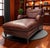 This elegant leather chaise lounge is upholstered in rich, reddish-brown top-grain leather that displays a beautiful...