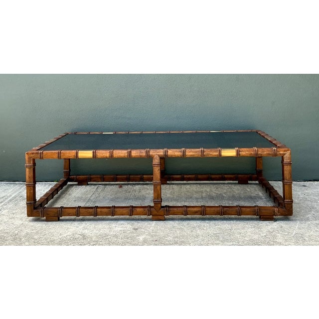 Showcasing mid-century tropical elegance, this large-scale rectangular coffee table features a carved solid wood frame...