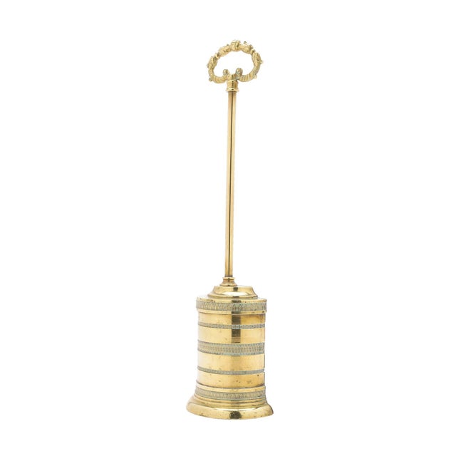 Half cylinder engine turned cast brass doorstop with a lead weighted base and detailed cast brass ring handle on a long...