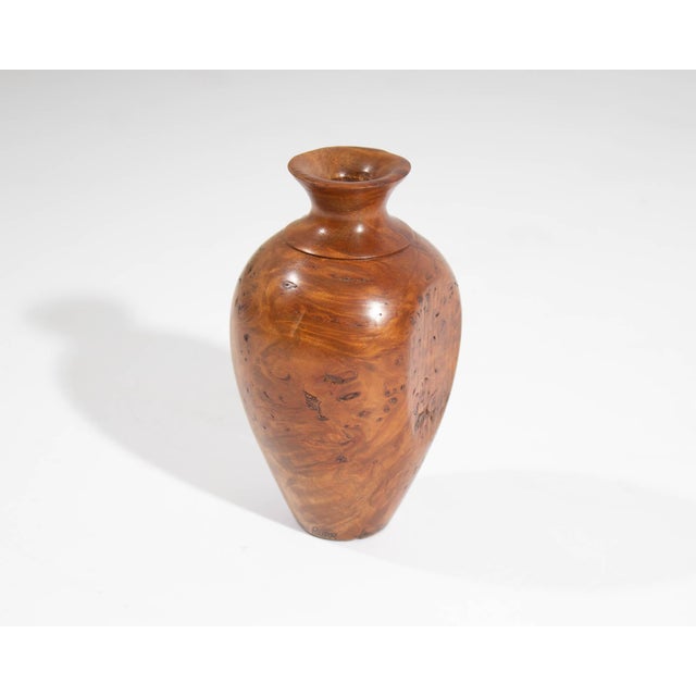 A wooden vase by New Zealand artisan Jim Robbie. Vase is made from Tawhai Burr wood. Signed to the bottom edge and marked...