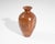 A wooden vase by New Zealand artisan Jim Robbie. Vase is made from Tawhai Burr wood. Signed to the bottom edge and marked...