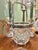 This vintage cut crystal ice bucket dates to approximately the 1930s–1940s, and features decorative silver-plated mounts...