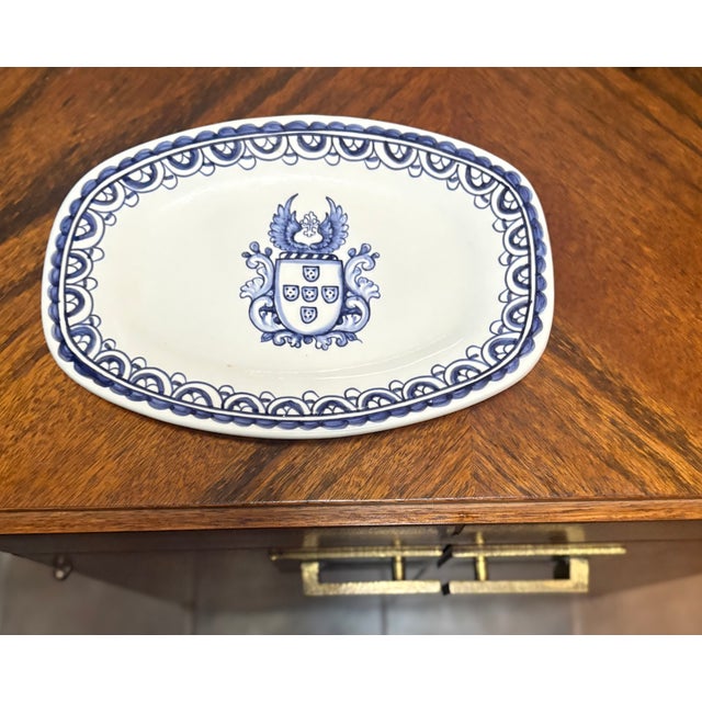 This traditional Portuguese folk art ceramic catchall dish features a coat of arms design known as the Brasao pattern....