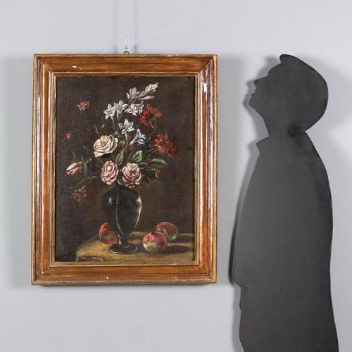 Oil on canvas. A simple composition of variegated and multicolored flowers in a vase, with some fruit scattered on the...