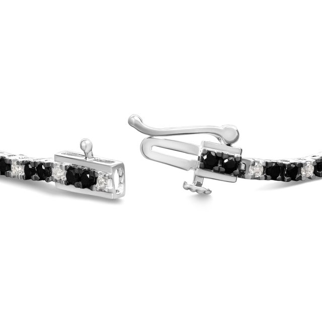 Draped in the twilight hues of a starlit sky, this resplendent .925 sterling silver tennis bracelet encapsulates both...