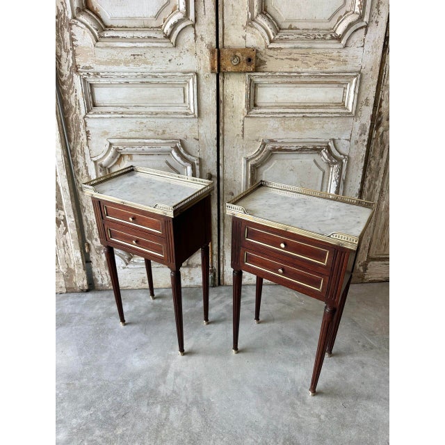 Pair of louis xvi style bedside tables, circa 1970. Two-drawer fronts. Good overall condition, some wear to the varnish....