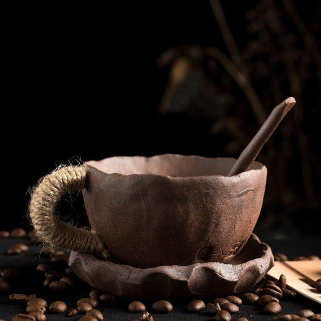 Handcrafted rough ceramic coffee cup and saucer with natural crackle glaze, showcasing a unique vintage texture. The hemp...