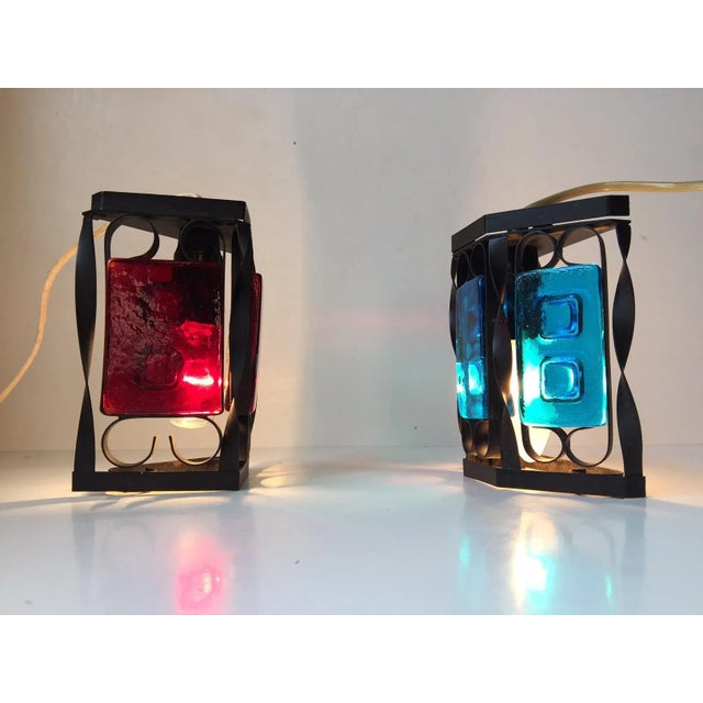 This set of Danish black iron and colored glass sconces was manufactured and designed in the 1970s as a collaboration...