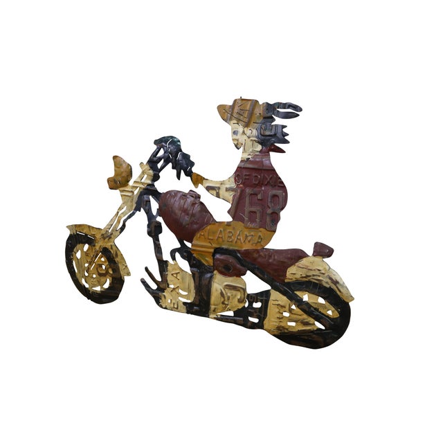 Vintage folk art wall sculpture made from repurposed license plates, depicting a person riding a motorcycle. Cut and...
