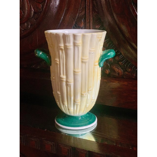Muted yellow tones make up the body of this Italian vase/cachepot which mimics stalks of bamboo. Green handles adorn each...