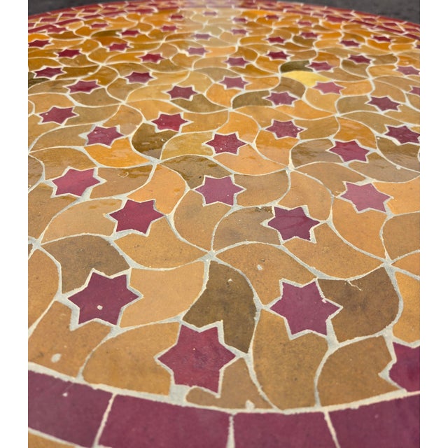 Beautiful handcrafted Moroccan mosaic table featuring an elegant honey and burgundy color palette. Measuring 32 inches in...