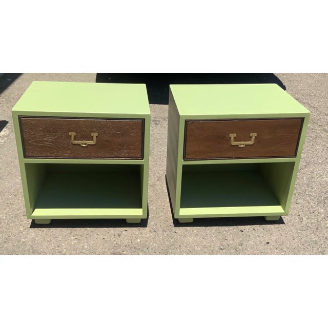 Pair of mid century campaign night stands. Pair is made of oak with a custom sea foam green finish with drawer faces done...