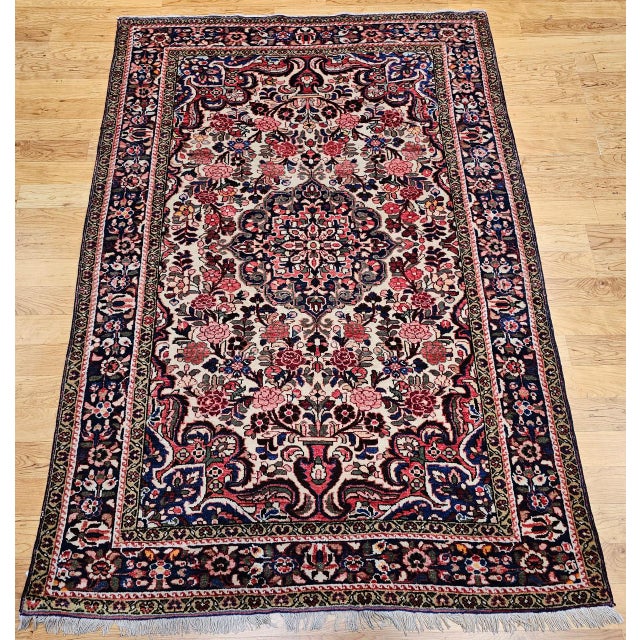 "This antique Persian Malayer area rug, woven in the early 20th century, is a striking example of the refined village...