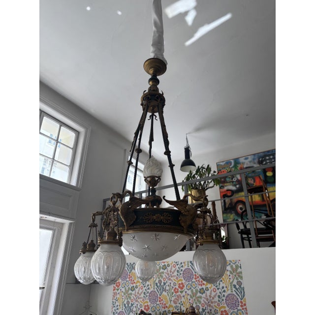 Empire Style Chandelier with finely decorated opal glass shades. This multi-light chandelier captivates with its...