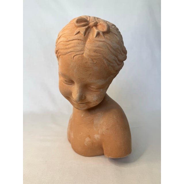 This bust is styled after French Neoclassic sculptor ohn Baptist Pigalle titled "La Rieuse" this adoring image of a...