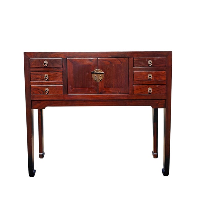 This vintage console table features a central two-door cabinet for storage, surrounded by three stacked drawers on each...