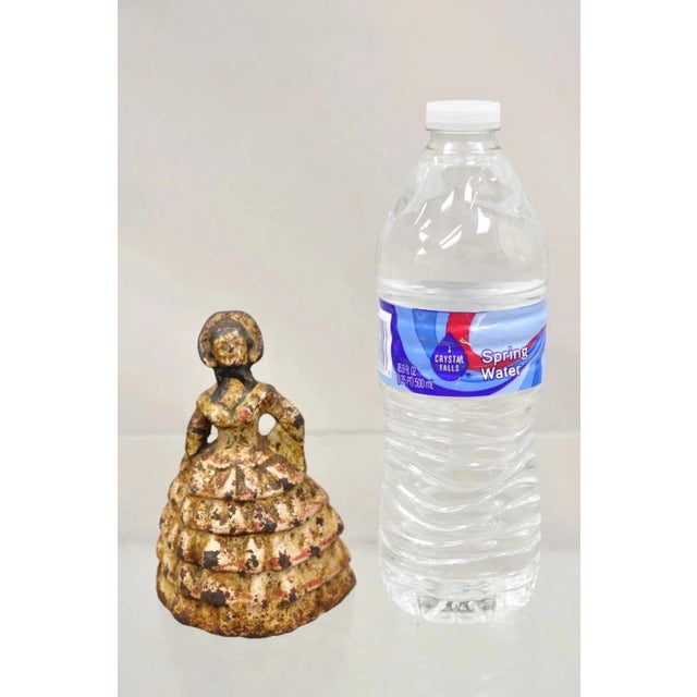 Antique Victorian Cast Iron Figural Painted Small Hoop Skirt Girl Door Stop. Circa Early 20th Century. Measurements: 4.5"...