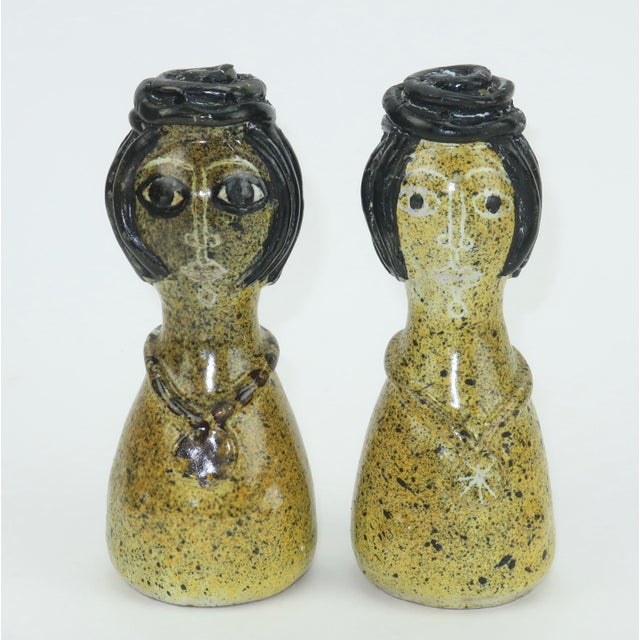 Figural art pottery salt & pepper shakers shaped like two women with top knot hairstyles and medallion necklaces which...