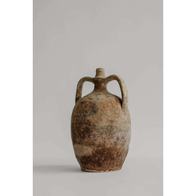 Hand-thrown terracotta vessel from Puglia, Italy, originally used for storing and carrying water or oil. Years of handling...