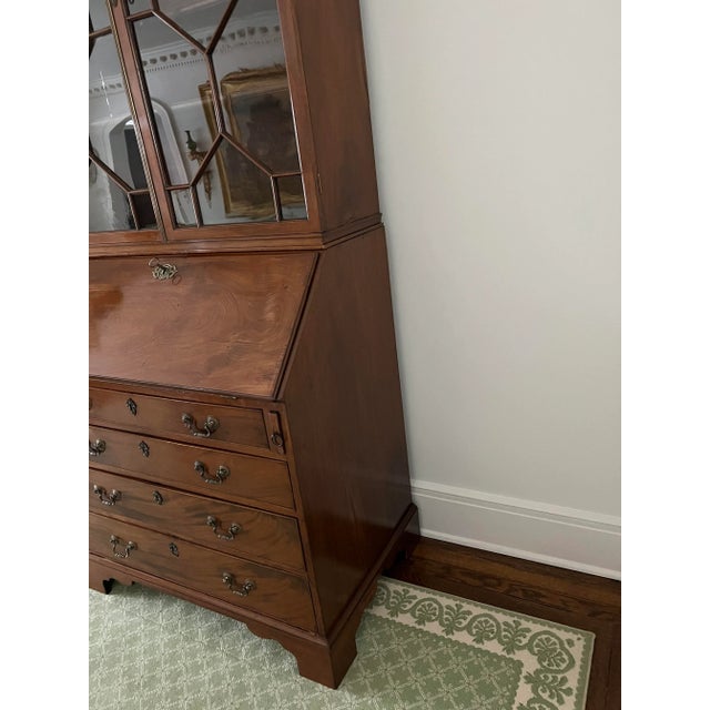Antique mahogany Georgian Chippendale slant front Secretary Desk with astragal glass doors supported by molded bracket...
