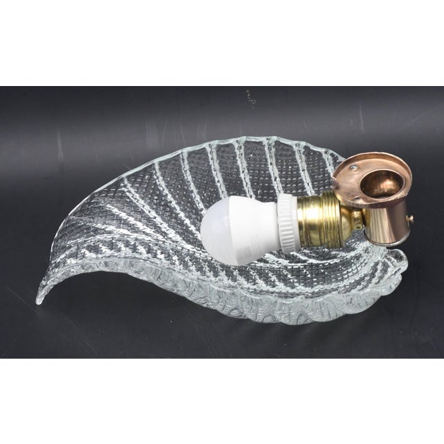 Stunning Murano wall light by artist Ercole Barovier. The wall light consist of a glass leave and a brass structure. It...