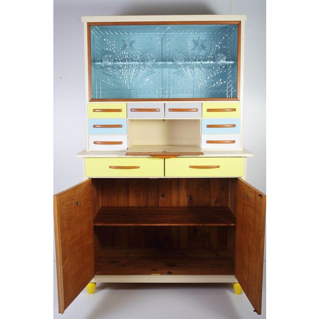 Completely restored. Consist of 2 pieces, top sitting on bottom one. Built to order at the time. Formica faces to oak...