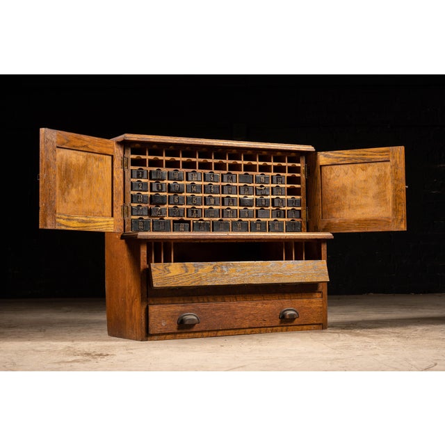 Vintage bench-top hardware cabinet constructed of wood. 30.5"W x 12.25"D x 26.5"H. This multipurpose industrial cabinet...