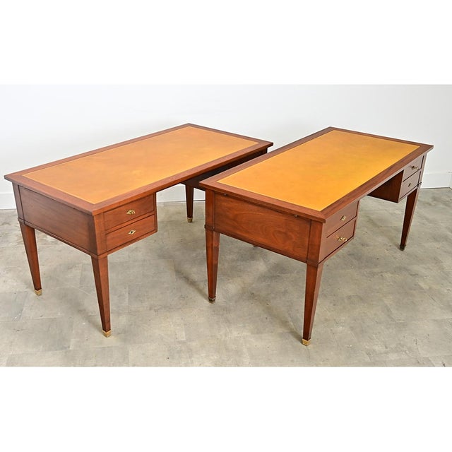A French 20th century leather-topped mahogany writing desk, designed in the Directoire taste for refined proportions &...