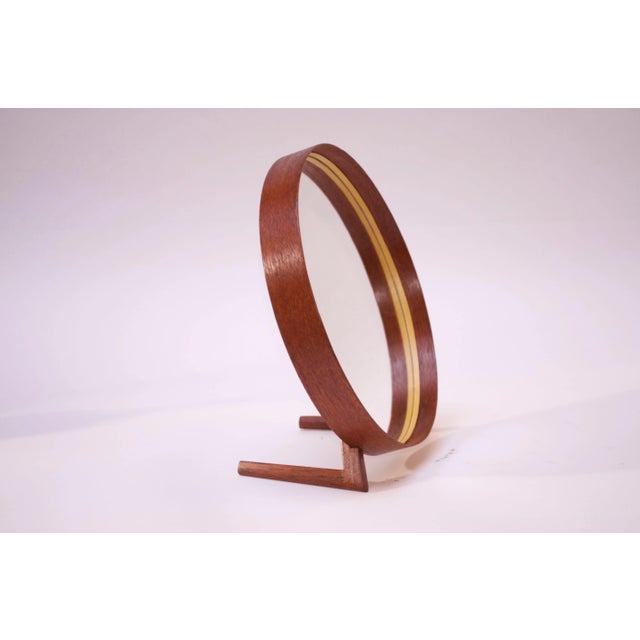 This teak and leather table mirror was designed by Uno and Östen Kristiansson for Luxus. The elegant simplicity of the...