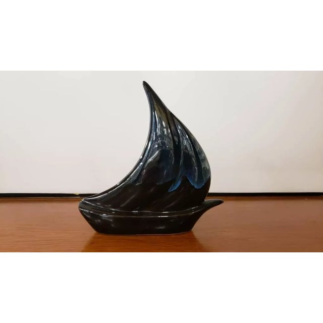 This is a 1970s Chinese Flambe Glaze Ceramic Sailboat Figurine. It measures 6" high, 6“ wide and 1 1/2" deep. The piece is...