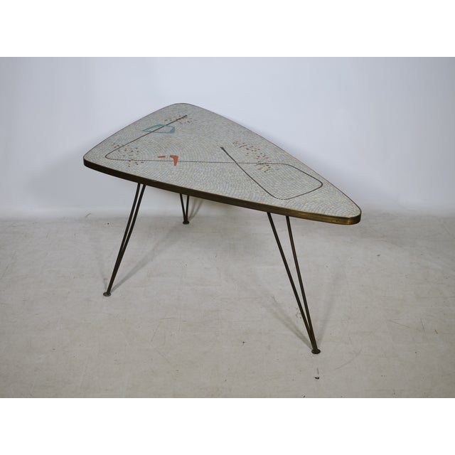 An exceptional mosaic kidney-shaped table by Berthold Müller-Oerlinghausen from the 1950s. The organically shaped tabletop...