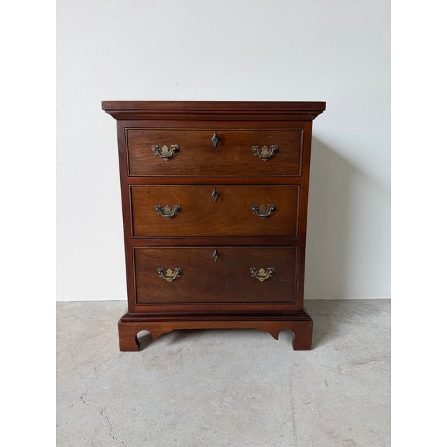 Elegant Early 20th Century Chippendale-style bachelor’s chest or small nightstand, crafted from solid mahogany with a rich...