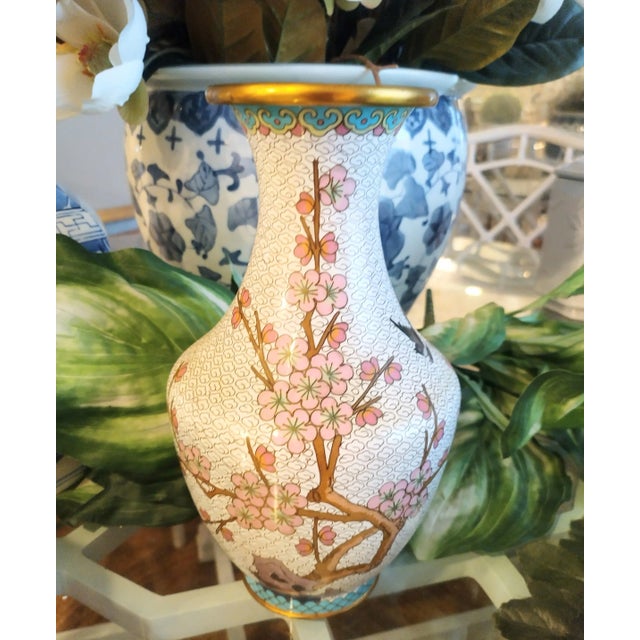 A beautiful Cloisonne Chinoiserie cherry blossom flower vase. The vas features a brass body adorned with a pretty Cherry...