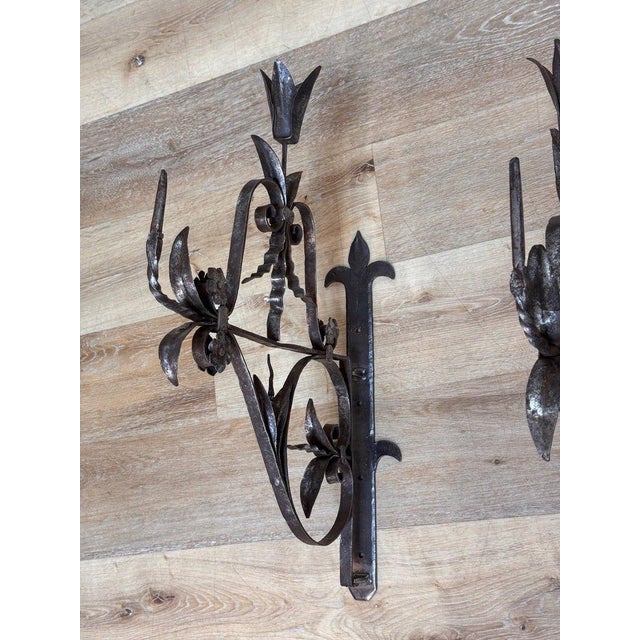 Superb pair of French hand-forged wrought iron wall brackets, dating 17th-18th century. Each features finely worked...
