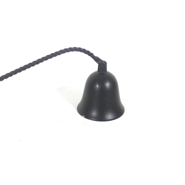 Black metal candle snuffer with a twisted and scrolled handle. Articulated cup. Old vintage patina with a few chips in the...