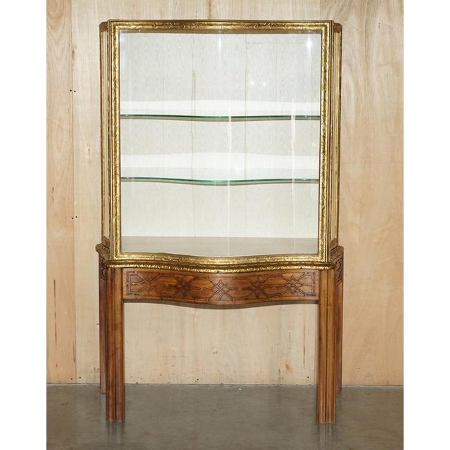 Thomas Chippendale carved, gold gilt oversized display cabinet with unique, serpentine fronted glazed front panel and side...