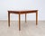 Large teak dining table with an elegant, slightly elliptical shape and two extension leaves. A masterpiece by Danish...