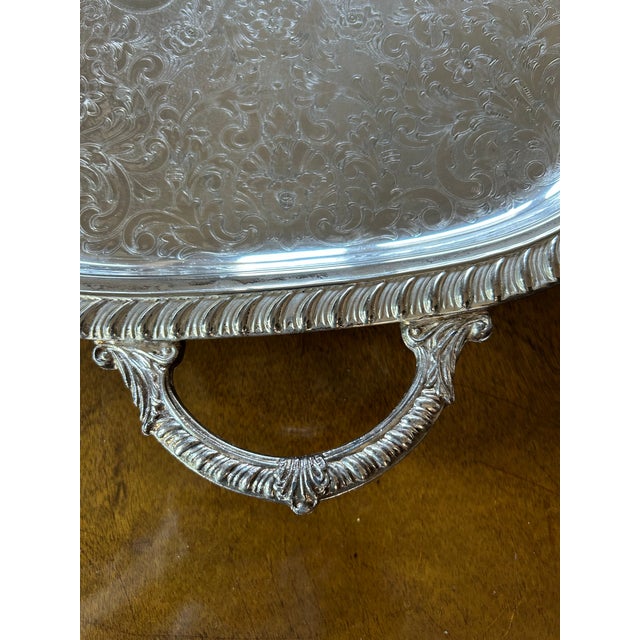 Designed by Leonard Silver this large elegant mid century vintage footed silver plate serving tray features a raised edge...