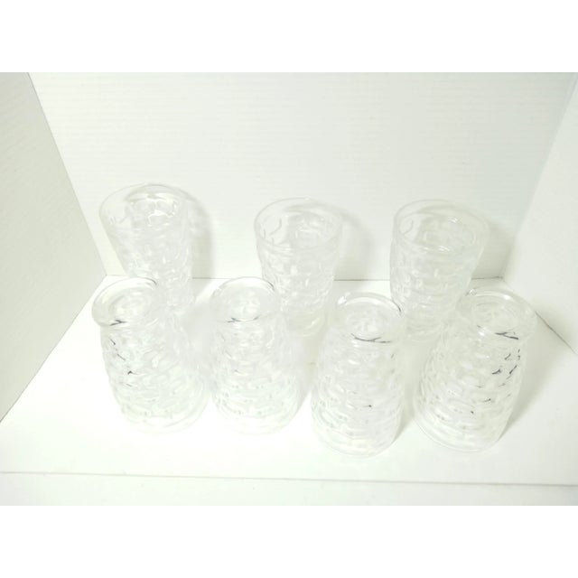 Seven nice tumblers. They hold around 10 ounces. They are about 5 1/2" tall and 3 1/4" wide. They are footed with a...