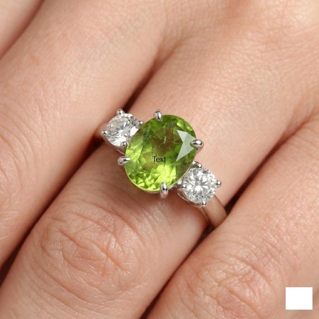 **Professional Product Description:** This elegant ring features a vibrant **Peridot gemstone** at its center, admired for...