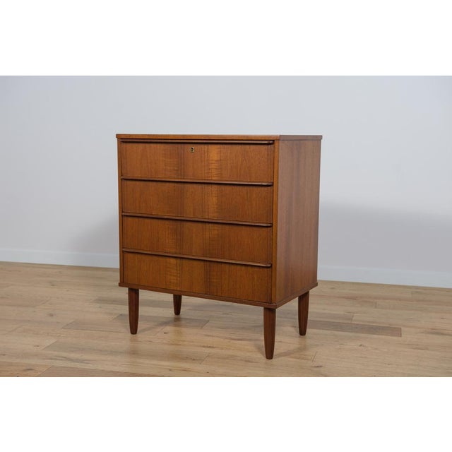 Mid-Century teak dresser made and manufactured during the 1960s in the Denmark. The dresser has profiled handles. The...