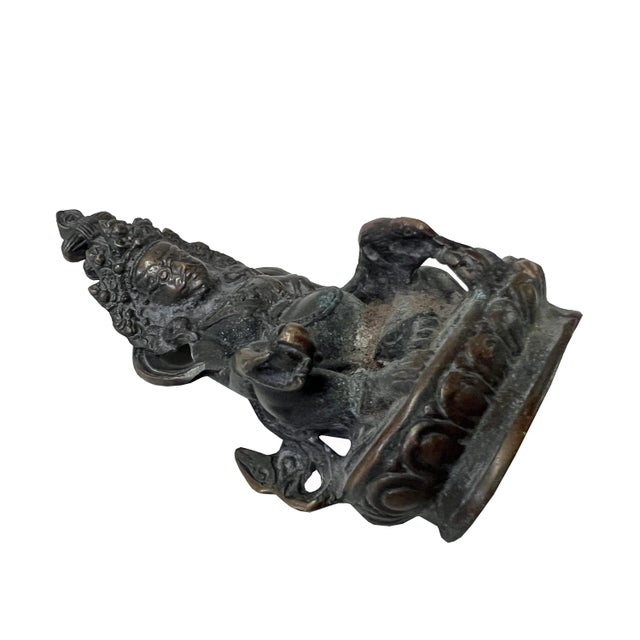 This is a decorative metal sitting Buddha Tibetan Zambala Fortune Deity statue. It is finished with a vintage rustic look....