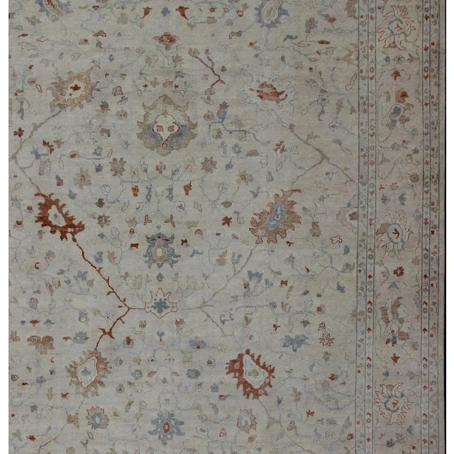 Large Modern Hand Knotted Oushak by Keivan Woven Arts Measures 12' x 15' This hand knotted Oushak rug features a beautiful...