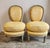 A charming pair of French balloon back slipper chairs feature beautifully carved frames with an antique distressed finish...
