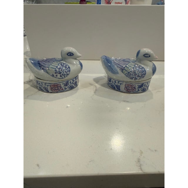 Porcelain vintage, hand painted lidded box in the shape of a duck — the lid is the duck itself, the base an oval box with...