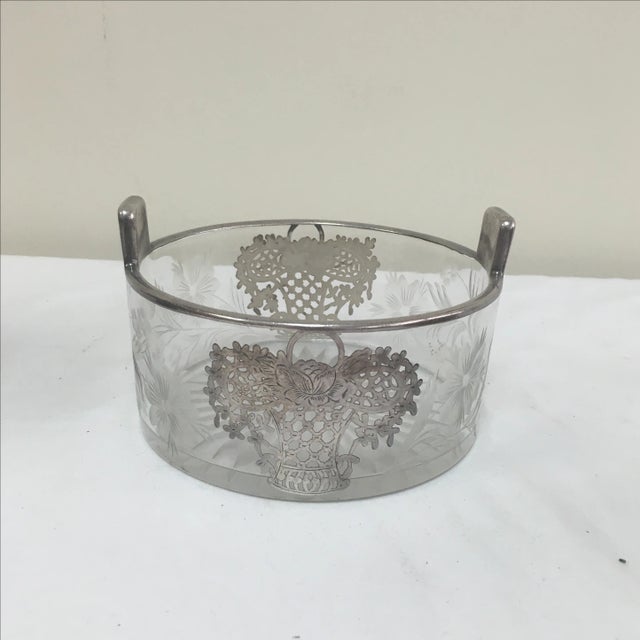 Circa 1940 silver overlay glass table-top ice bucket with basket of flowers on each side. Etched flowers throughout.