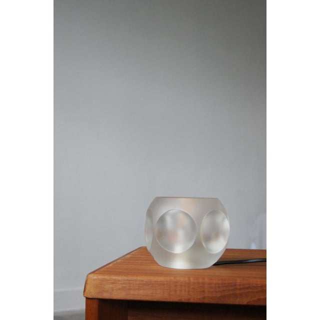 The TA14 table lamp produced by Peill & Putzler in the 1970s generates soft, diffused light. The shape of the transparent...